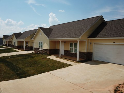 A row of houses with a clear blue sky above them.