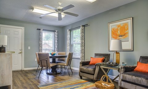 A living room with a dining table and chairs.
