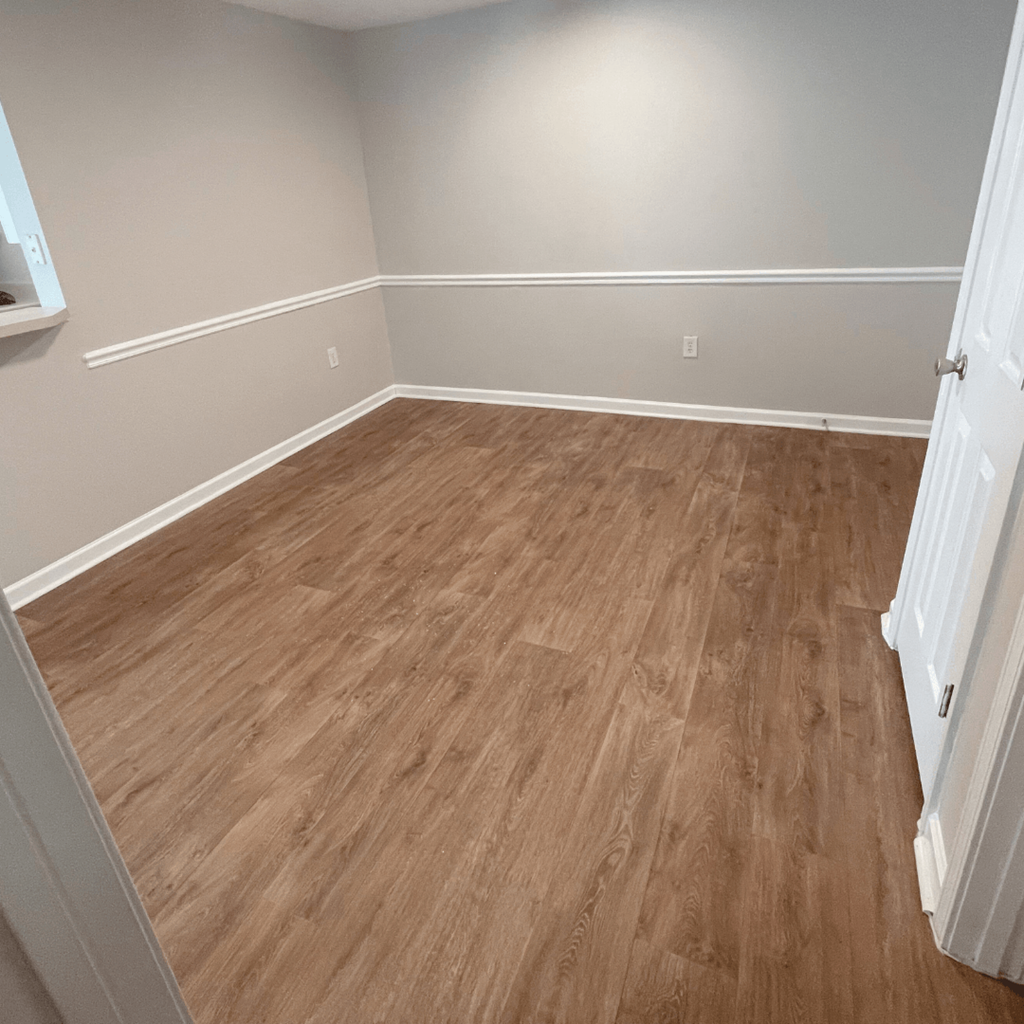 an empty room with hardwood floors