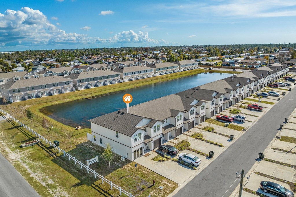 an aerial view of a row of houses next to a lake