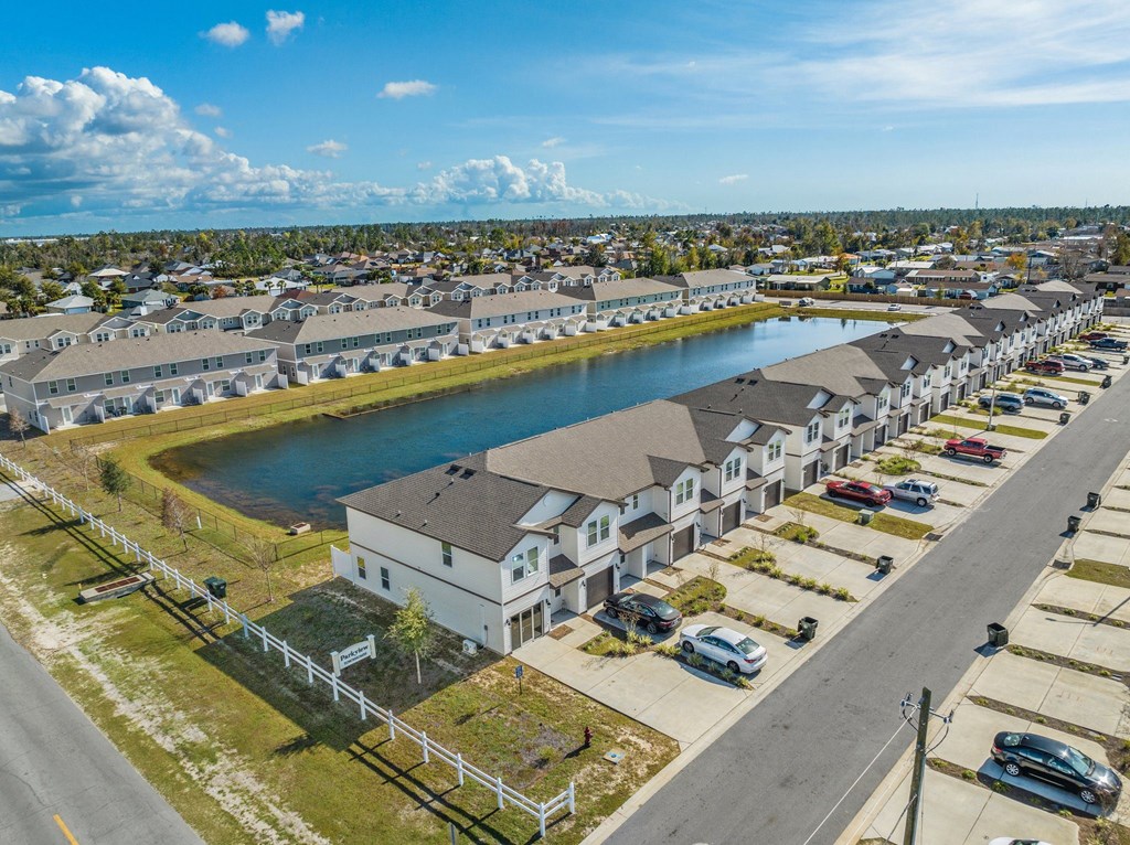 an aerial view of a row of houses next to a lake