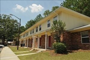 A two-story building with a yellow top and a brick bottom.