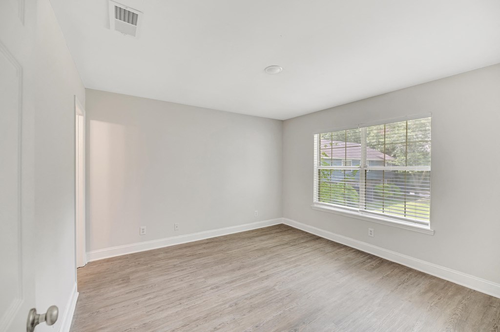 A room with a window and a door.