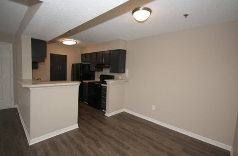 A kitchen area with a refrigerator, microwave, and oven.