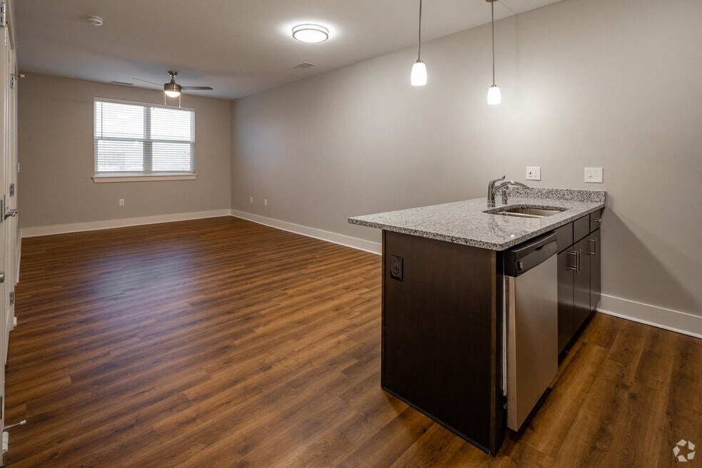 an empty kitchen and living room with a counter top