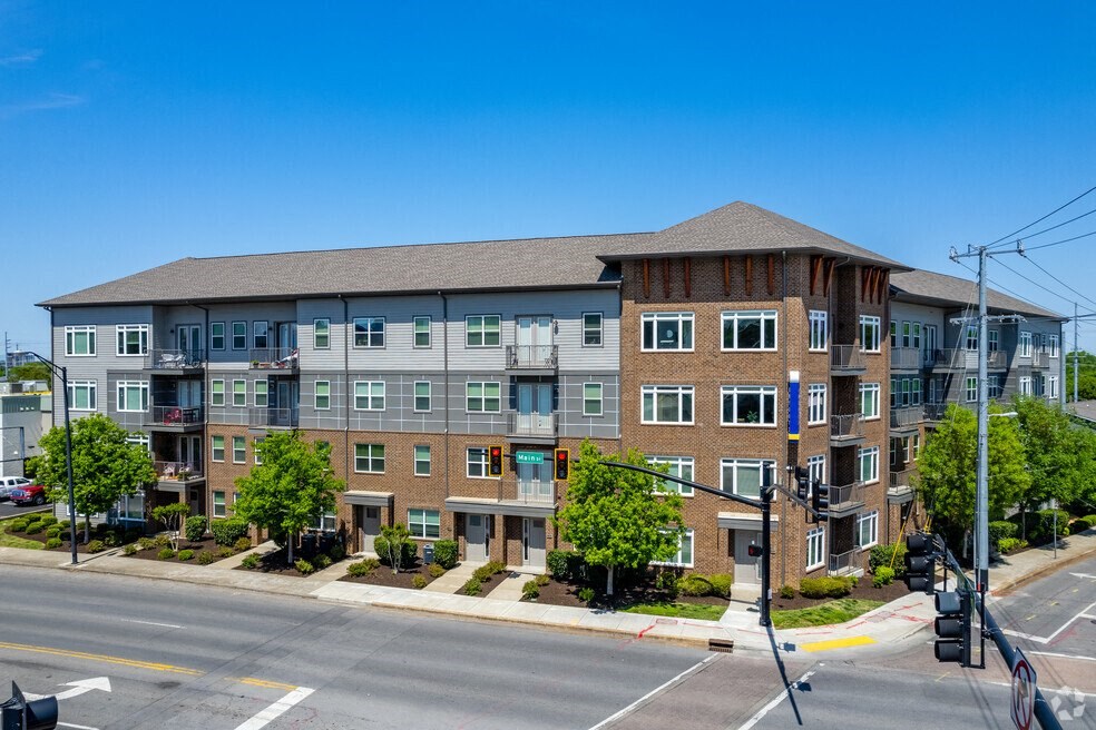 a large apartment building on the corner of a street