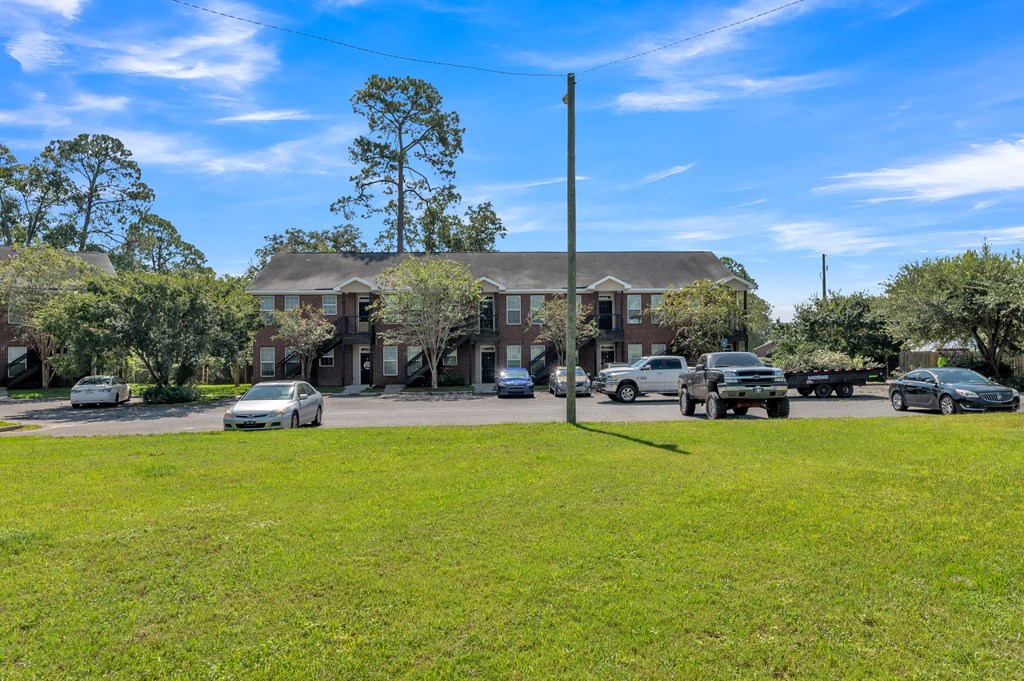 the front of a house with cars parked in front of it