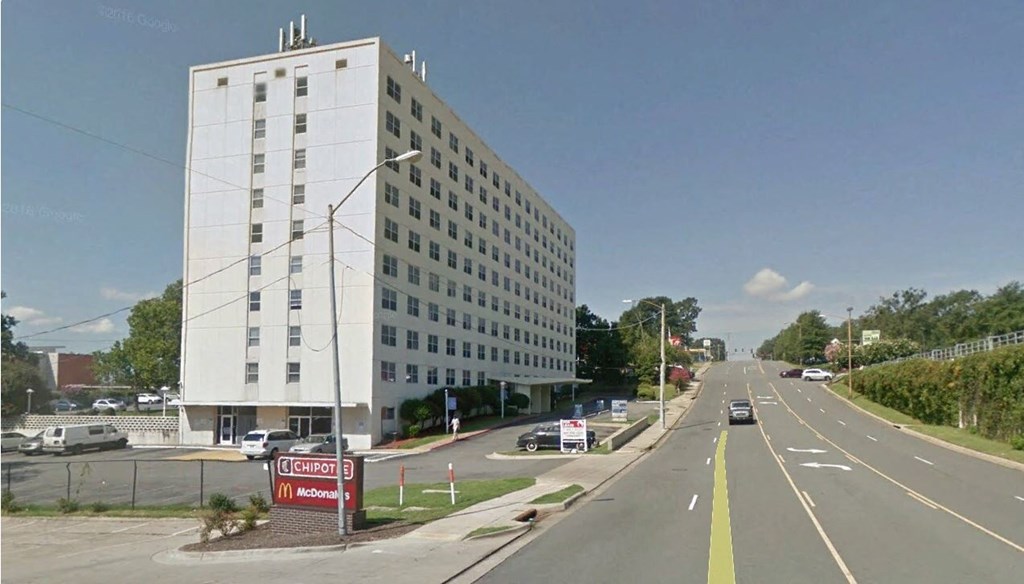 a large white building on the side of a road