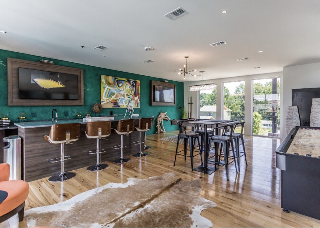 the living room of a house with a bar and a television