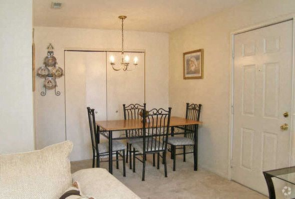 a dining room with a table and a couch