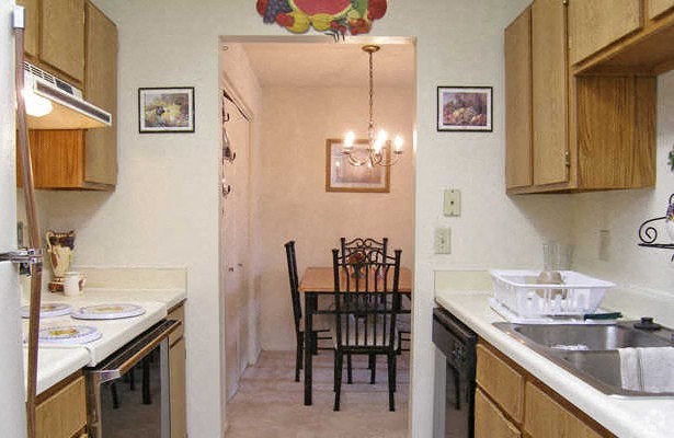 a kitchen and dining room with a table and chairs