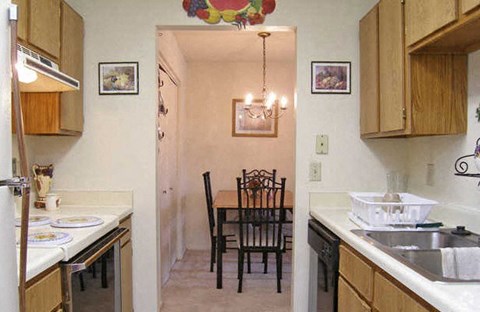 a kitchen and dining room with a table and chairs