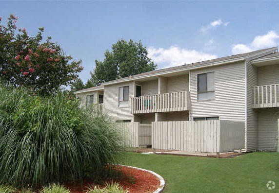 a white house with a yard and a white fence