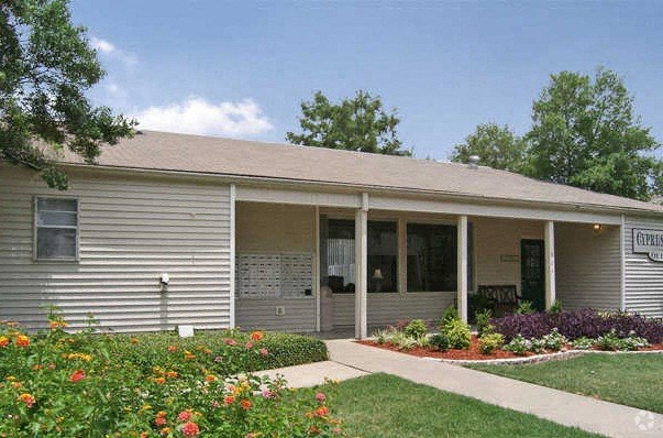 a white house with a porch and a garden