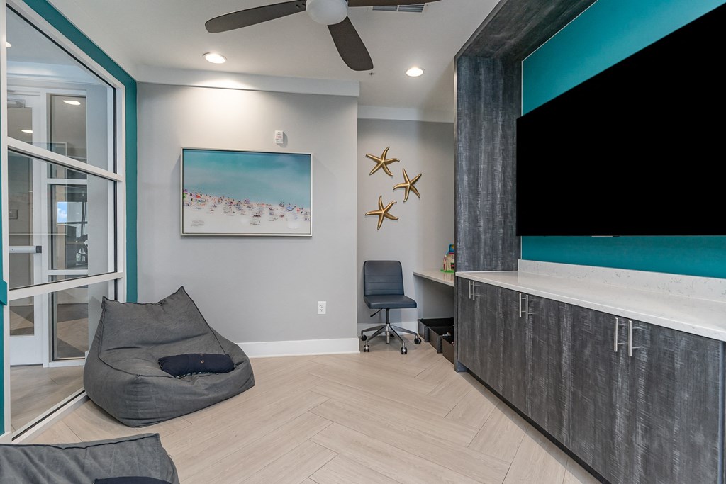 a room with a large tv and a bean bag chair