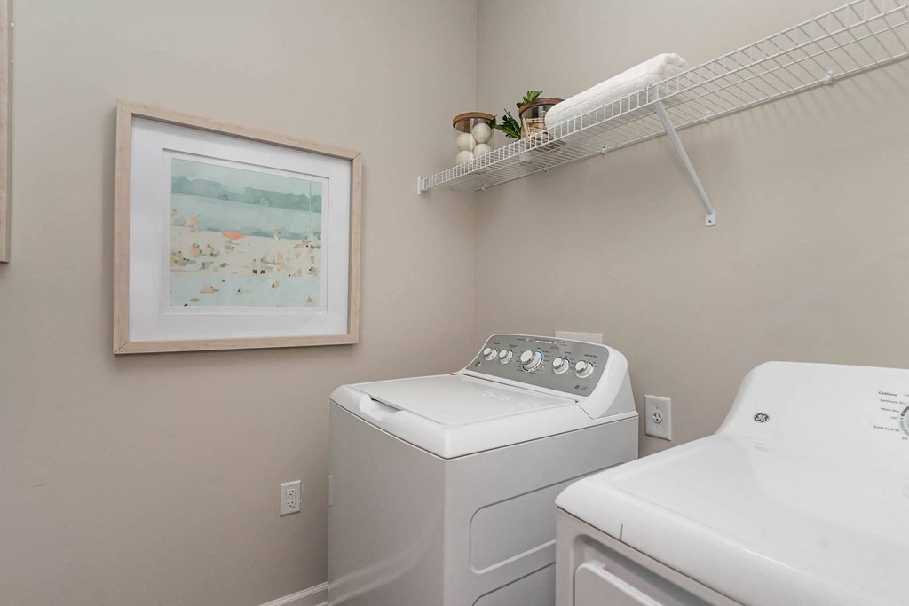 a white washer and dryer in a gray laundry room