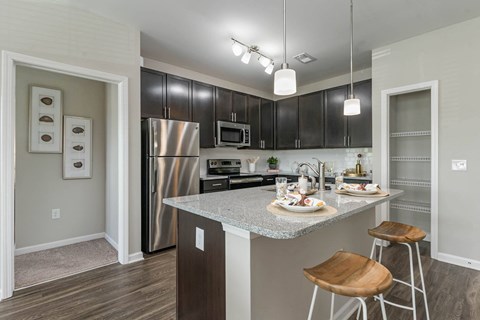 a kitchen with stainless steel appliances and granite counter tops