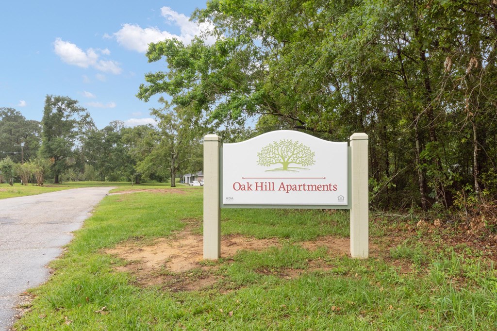 a sign with oak hill apartments written on it