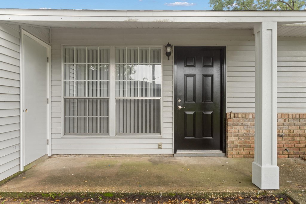the front of a house with a black door