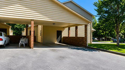 A house with a garage and a car parked in front.