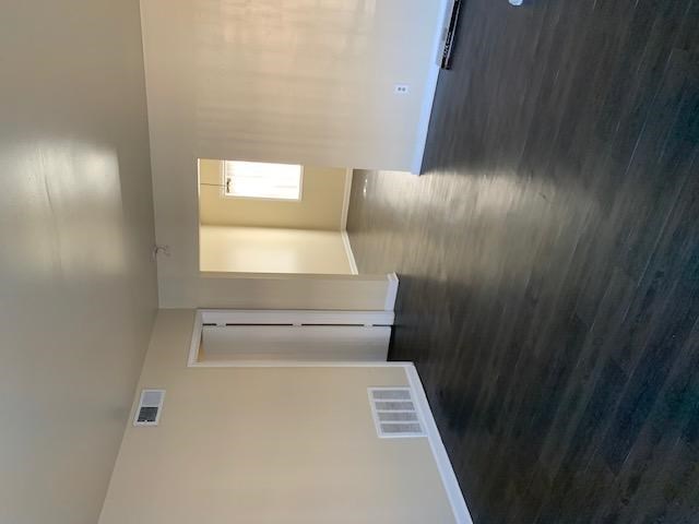 A small room with a window and a vent.