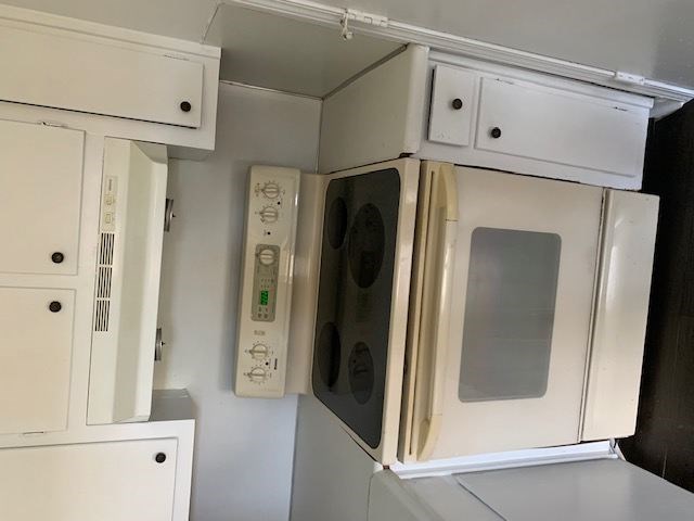 A white microwave oven with its door open and control panel visible.