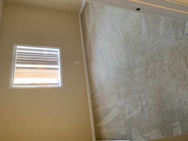 A window with blinds is on the wall.