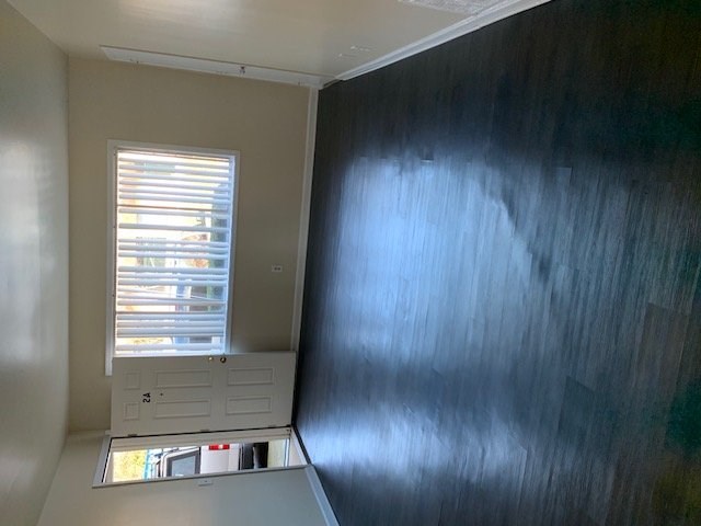 A room with a window and a door.