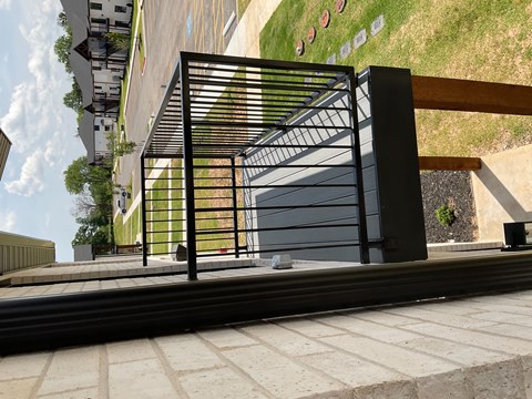 a large black metal gate in front of a building