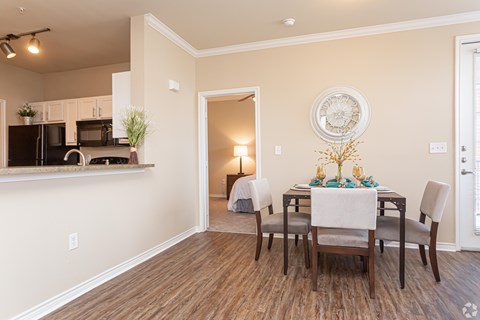 A dining room with a table set for four.