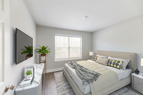 a bedroom with a large bed and a tv
