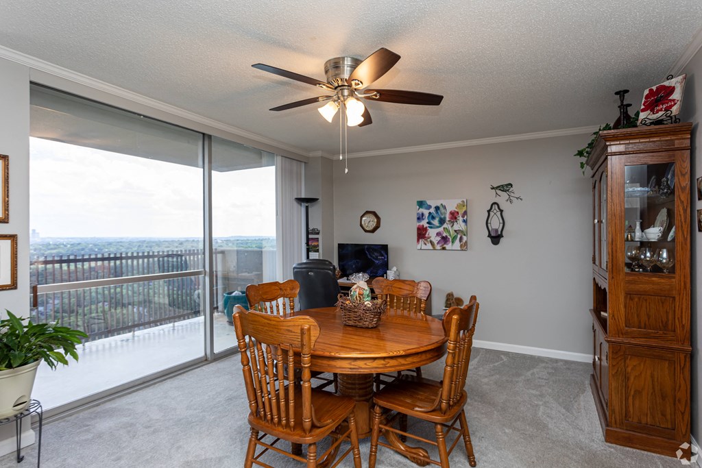 the dining room is open to the living room and balcony