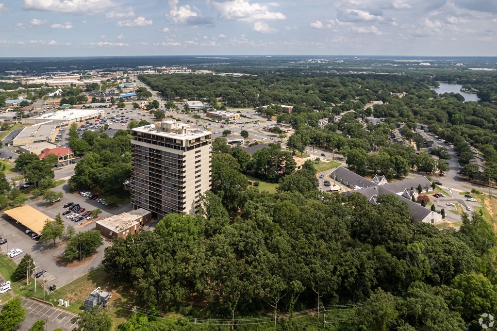 an aerial view of a city with a tall building