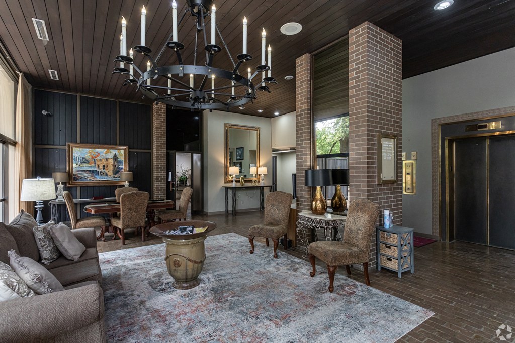 a large living room with a large chandelier and furniture