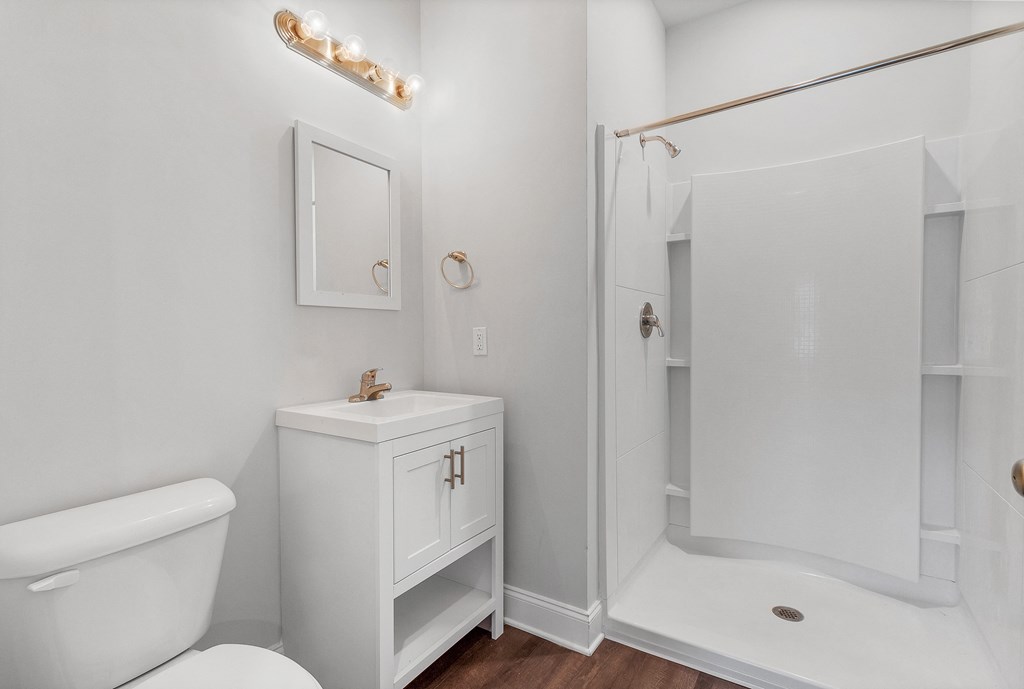 a bathroom with a toilet sink and shower