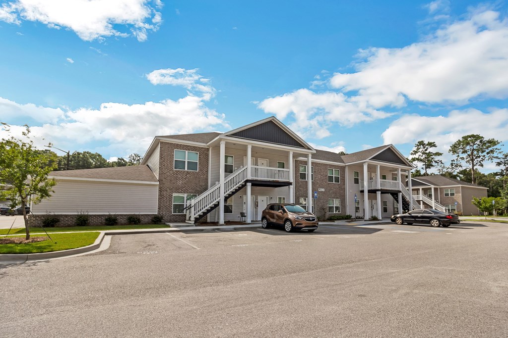 a large house with a parking lot in front of it