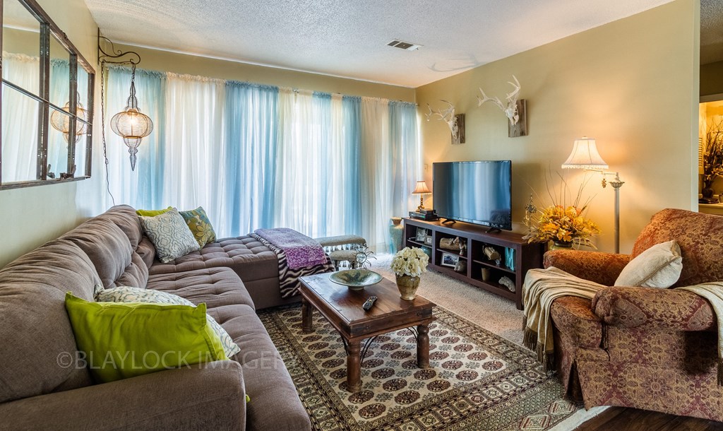 a living room filled with furniture and a flat screen tv