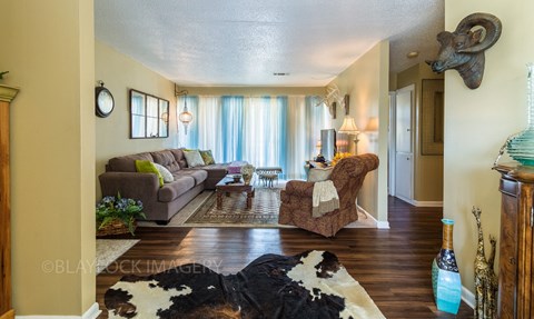 a living room with a couch chair and coffee table