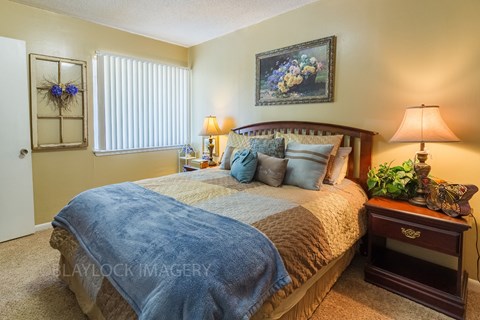 a bedroom with a bed and two nightstands