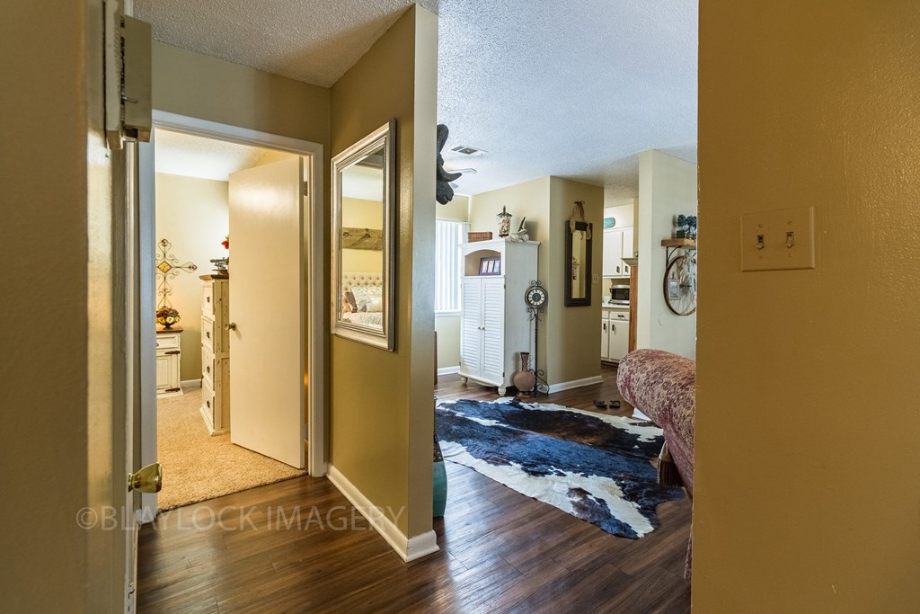 a bedroom with a bed and a bathroom in the background