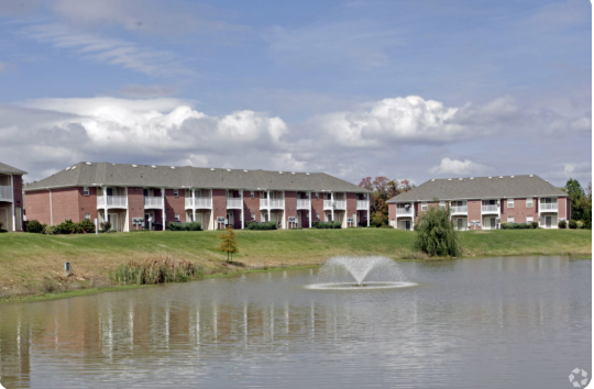 A building with a fountain in front of it.