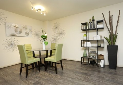 A dining room with a table and chairs.