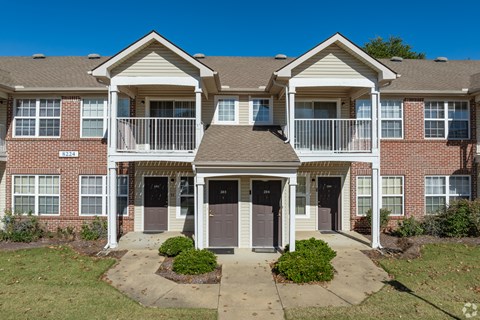 A large brick building with a balcony in the front.