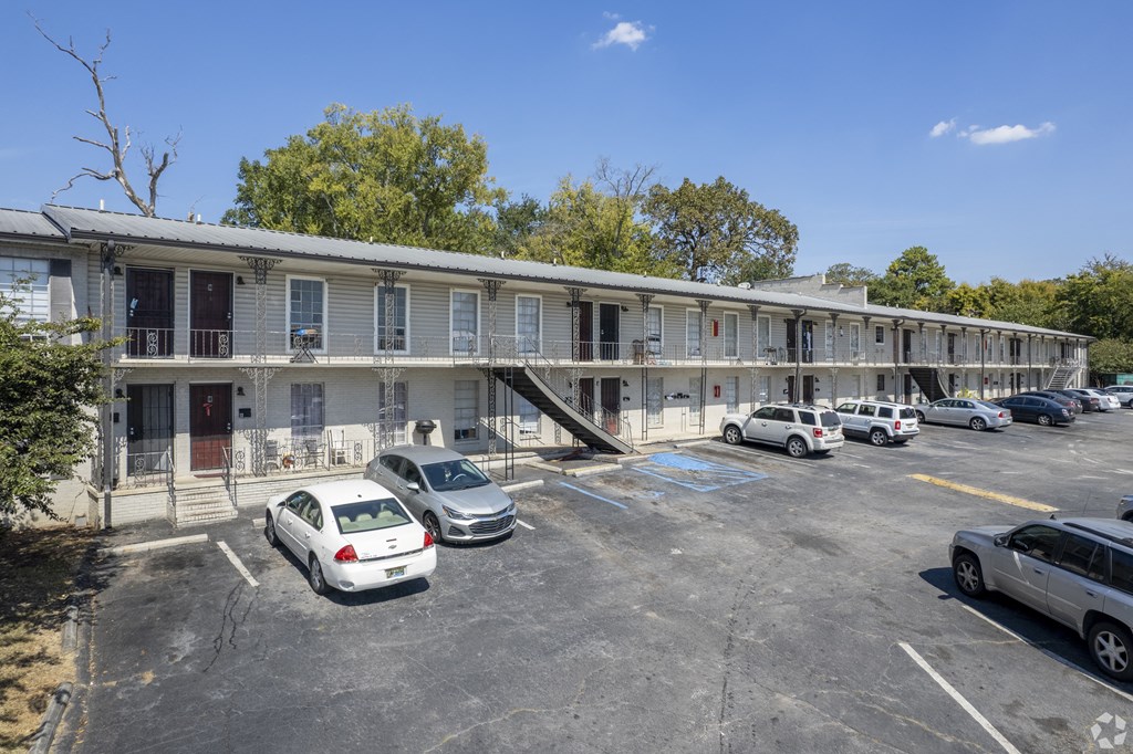 a motel building with cars parked in front of it