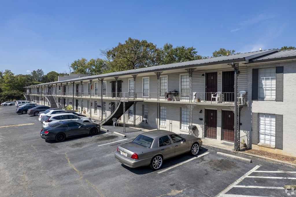 an apartment building with cars parked in front of it