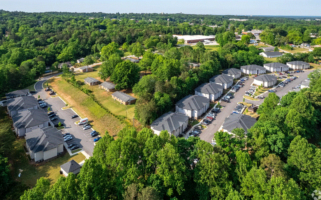 an aerial view of a row of houses surrounded by trees