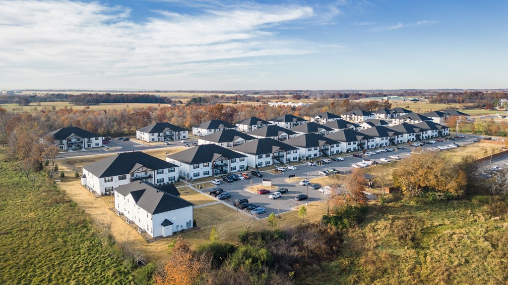 an aerial view of a group of houses in a parking lot