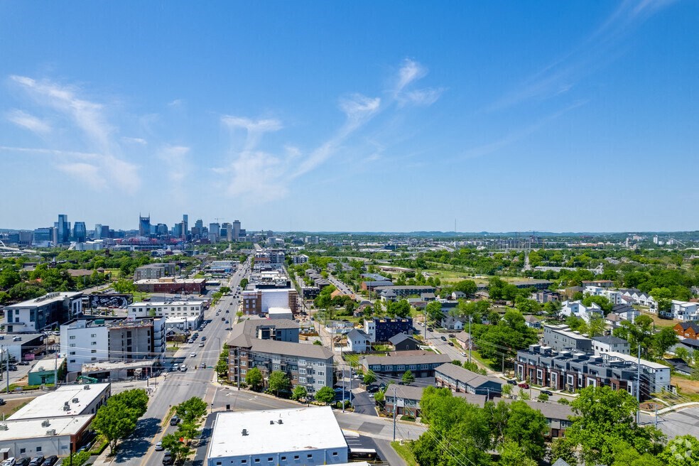 an aerial view of the city with the skyline in the distance