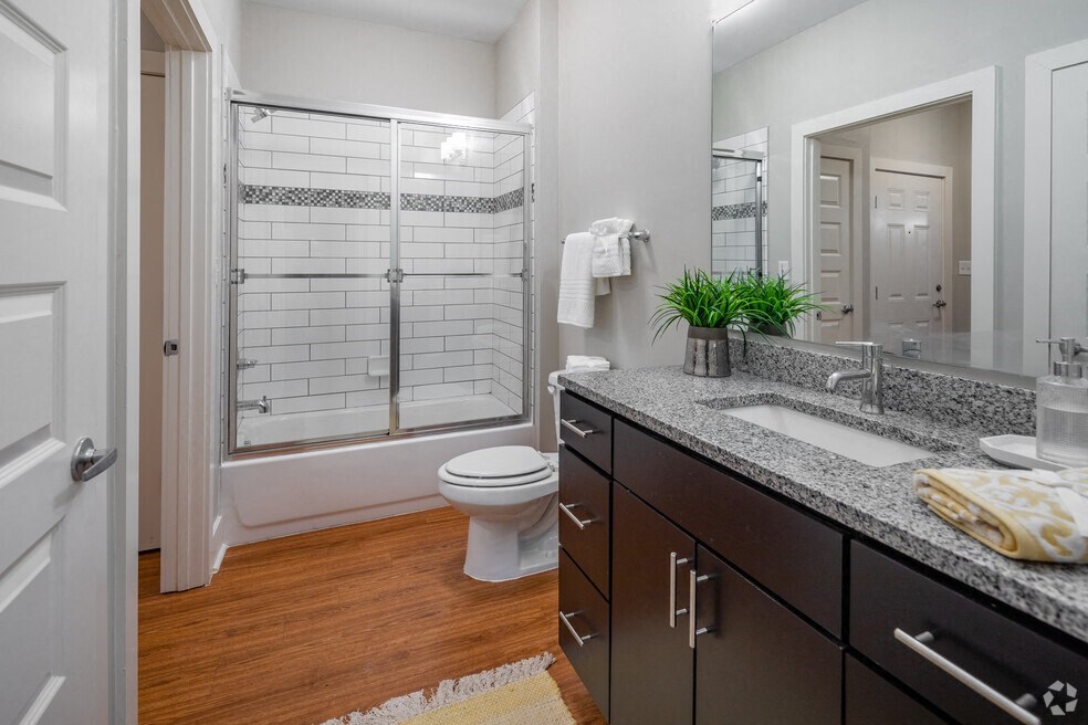 a bathroom with a sink and a shower and a toilet