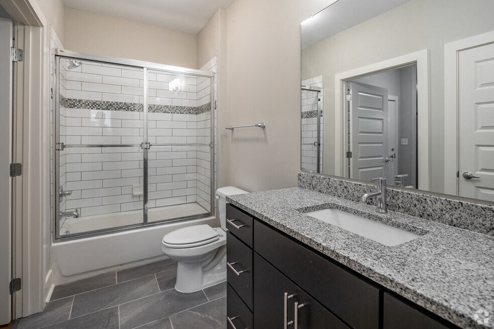 a bathroom with a sink and a toilet and a shower